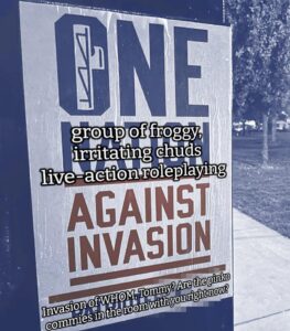 A propaganda photo of a Patriot Front poster pasted to a utility box somewhere in the U.S. The image itself has had its hue adjusted, to give it a blue pall. The poster reads "One Nation Against Invasion," with the text in blue and red. The center of the letter "O" in "One" has been stylized to resemble a set of fasces. The image has been intentionally, digitally defaced to read "One group of froggy, irritating chuds live-action roleplaying Against Invasion. Invasion of WHOM, Tommy? Are the pinko commies in the room with you right now?" The "Tommy" in question is Thomas Rousseau, the man at the top of Patriot Front's model of white supremacist pyramid scheme. The URL for the official Patriot Front website is printed at the bottom of the poster; it has been intentionally defaced to obscure it.