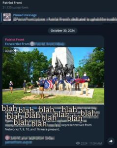 A screenshot from Patriot Front's Telegram channel, dated October 30th, 2024. The post contains a video, the captured still of which depicts 18 or so members standing in front of The State of Virginia Monument in Gettysburg National Military Park, in Gettysburg PA. A 19th member likely holds the camera from which the video was recorded. The text of the post has been intentionally defaced with the word "blah" several times, save a section: "Representatives from Networks 7, 9, 10, and 16 were present."