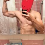 A shirtless bathroom selfie apparently taken by Brooks, circa October 2022. Brooks flexes his right arm while taking the selfie with his left hand. Brooks has redacted his face, but not the tattoo on his right arm.