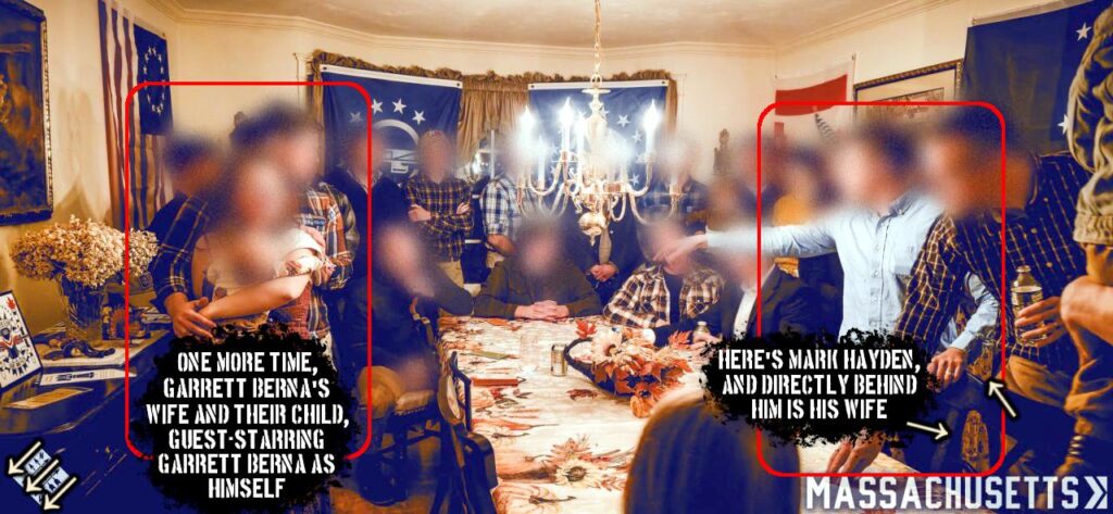 A photo of the Network 7 Frontsgiving, heavily marked and defaced. The photo is taken in a spacious dining room, with a table that has not yet been set for a meal. Around it are several members of Patriot Front and their families, faces blurred. One group to the left has been circled in red and marked "one more time, Garrett Berna's wife and their child, guest-starring Garrett Berna as himself". The wife and child are wearing the same outfits as they were in the photo taken on the front porch during and uploaded on the 17th. Another group to the right has been marked as "here's Mark Hayden, and directly behind him is his wife." Hayden is wearing the same outfit as he was in the photo taken on the front porch during and uploaded on the 17th, and a figure barely visible behind him is wearing the same paisley-patterned dress as his wife in the same aforementioned photo.